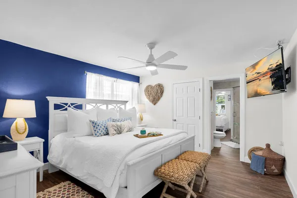 a bedroom with a bed and wooden floor