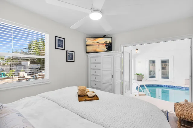 a bedroom with a bed and a flat screen tv