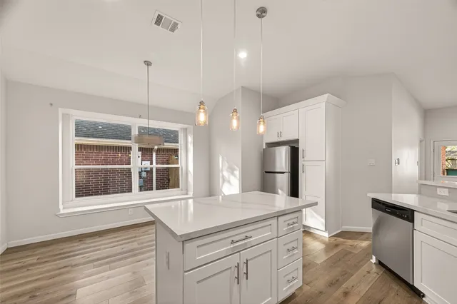 a kitchen with a stove a sink and a refrigerator