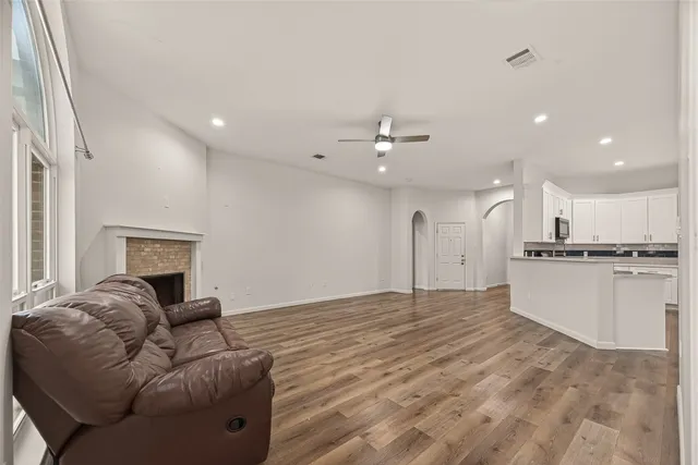 a living room with furniture and kitchen view