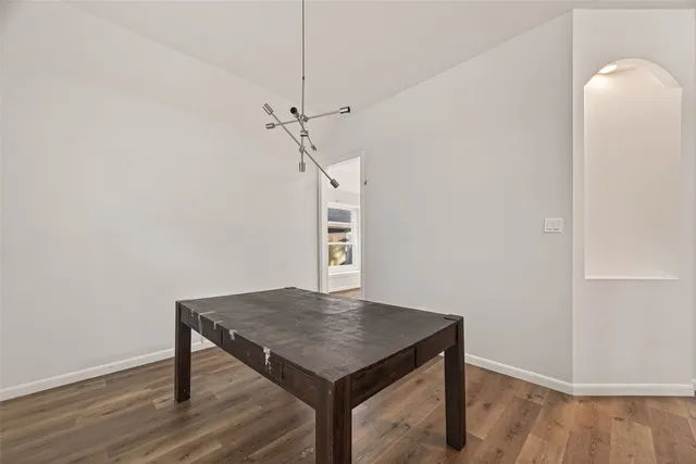 a view of a room with a table and chairs