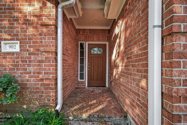 a view of a brick house with a door and a window