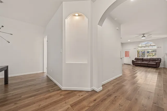 a view of a livingroom with furniture and a hallway