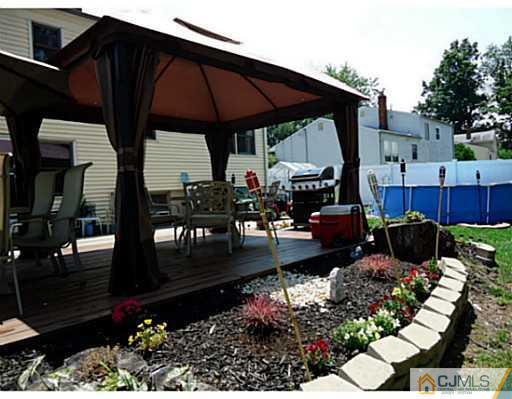 13 Monaghan Road Edison, NJ 08817 - Photo 22 of 24 a view of a patio with table and chairs potted plants