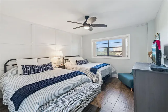 a bedroom with two bed and a chandelier