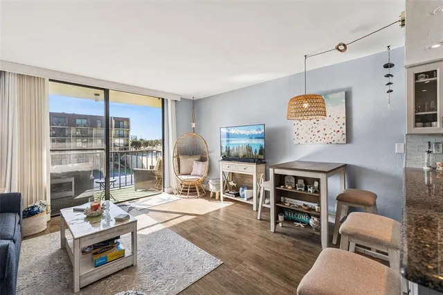 a living room with furniture and a floor to ceiling window