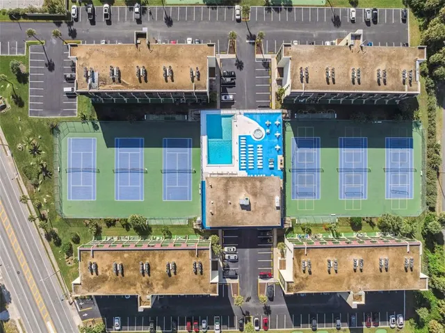 an aerial view of a swimming pool with outdoor seating