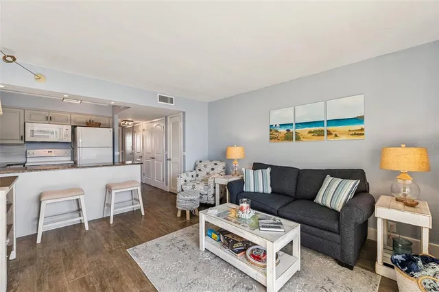 a living room with furniture a rug and a table