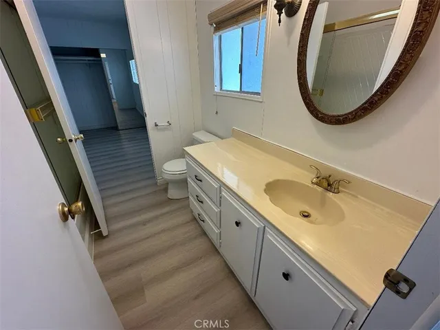 a spacious bathroom with a granite countertop sink and a mirror