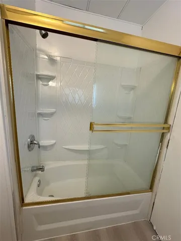 a bathroom with bathtub and shower