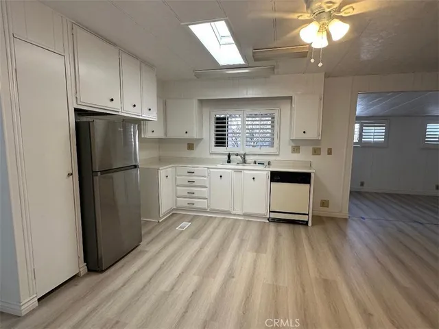 a kitchen with stainless steel appliances a refrigerator sink and cabinets