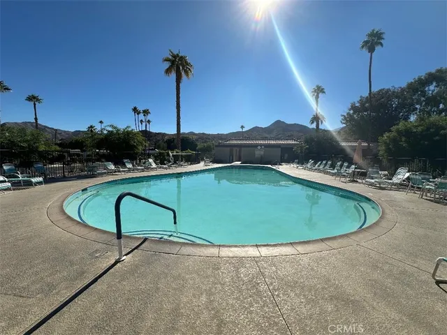 a view of a swimming pool and a yard