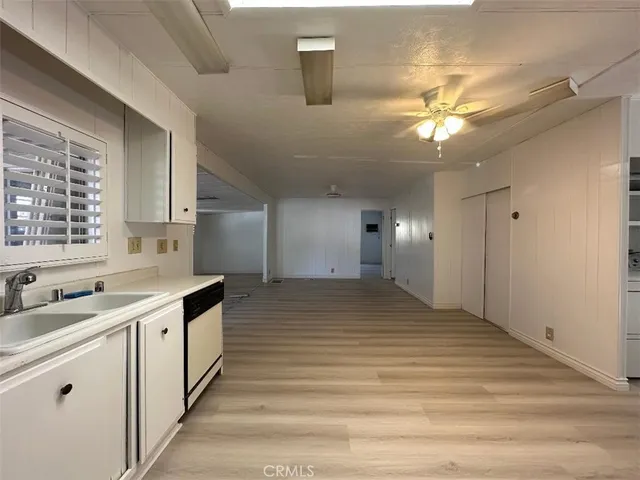 a view of a kitchen with a sink and a window