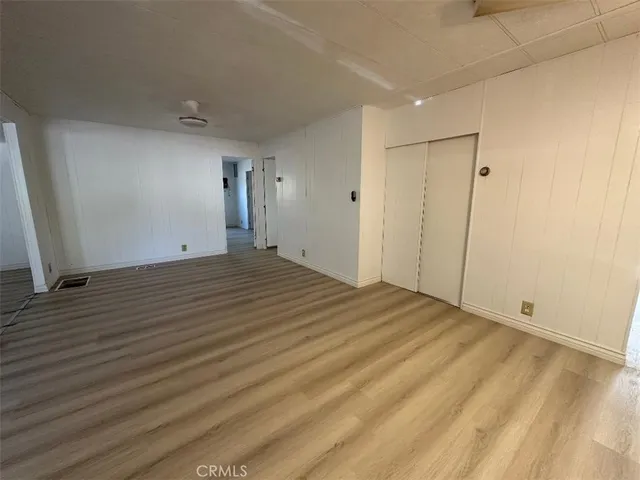 a view of a room with wooden floor