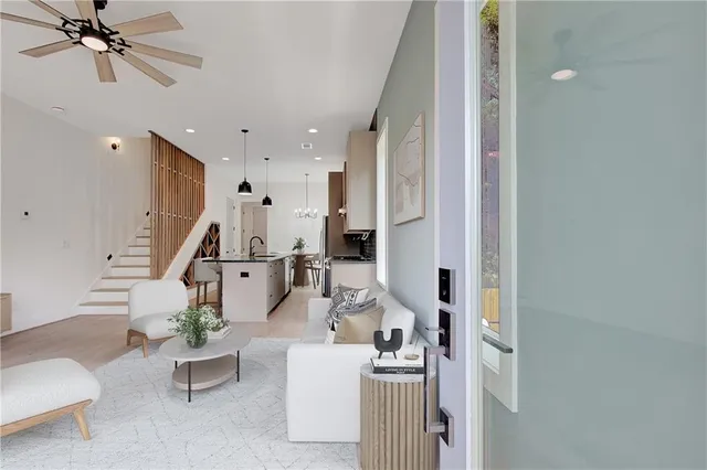 a view of a hallway with wooden floor and staircase