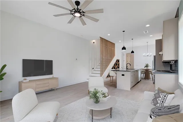 a view of a kitchen with sink and stainless steel appliances