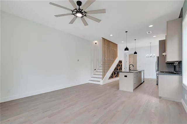 a bathroom with a granite countertop toilet a sink and a mirror