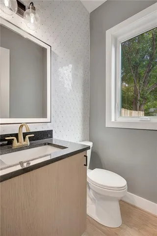 a bathroom with a toilet a sink and a window