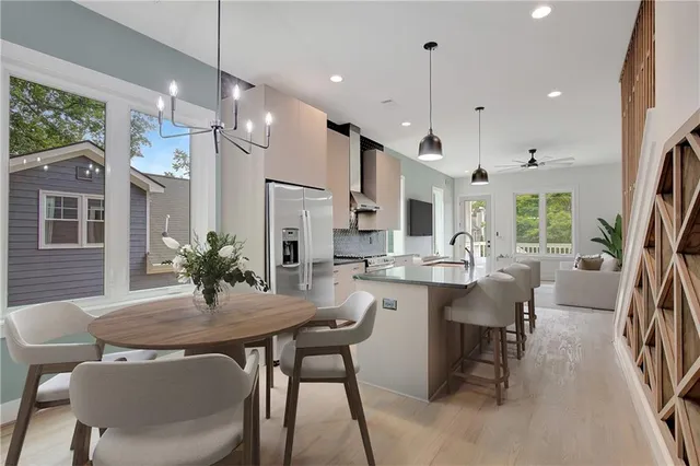 a dining room with furniture a chandelier and wooden floor
