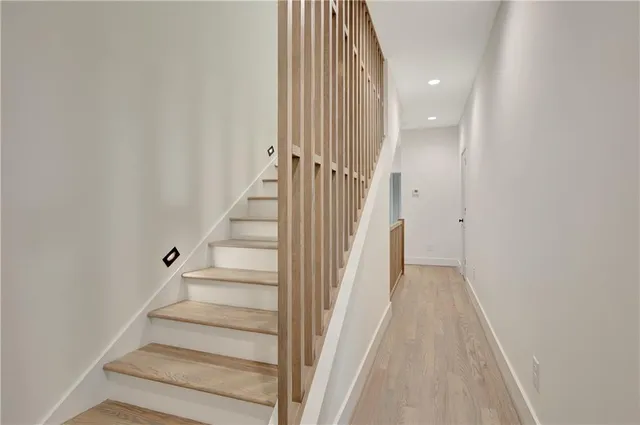 a bathroom with a toilet a sink a tub and mirror