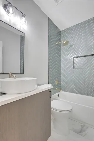 a bathroom with a toilet a sink and bathtub