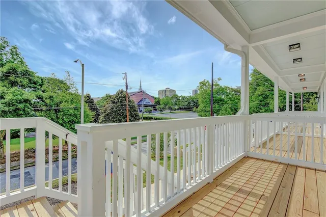 a front view of a house with a yard and potted plants