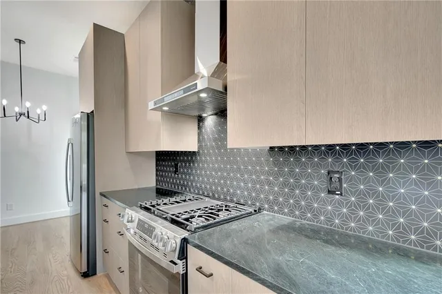 a kitchen with granite countertop a stove and a sink