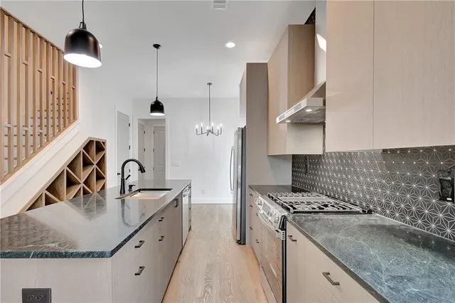 a kitchen with a sink stove and refrigerator