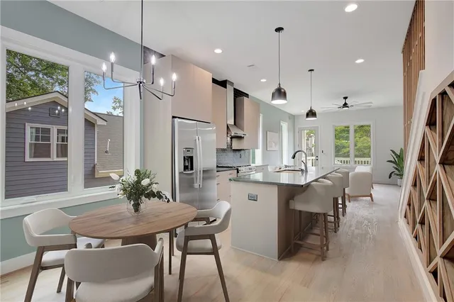 a dining room filled chandelier and wooden floor