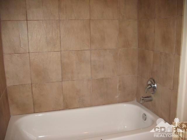 13827 Ocotillo Road Desert Hot Springs, CA 92240 - Photo 11 of 15 a bathroom with a bathtub