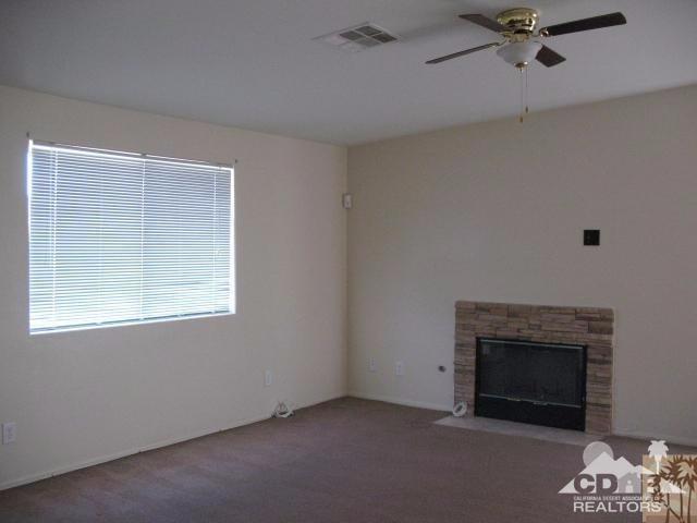 13827 Ocotillo Road Desert Hot Springs, CA 92240 - Photo 2 of 15 a view of livingroom with a fireplace