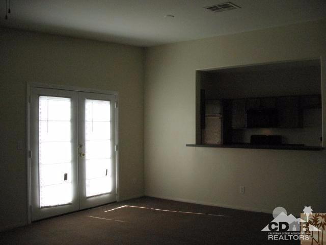 13827 Ocotillo Road Desert Hot Springs, CA 92240 - Photo 3 of 15 a room with a fireplace and a wooden floor
