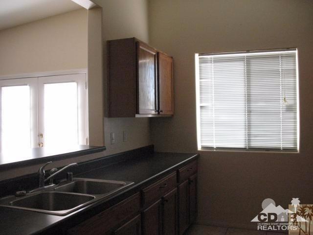 13827 Ocotillo Road Desert Hot Springs, CA 92240 - Photo 5 of 15 a kitchen that has a sink and a window