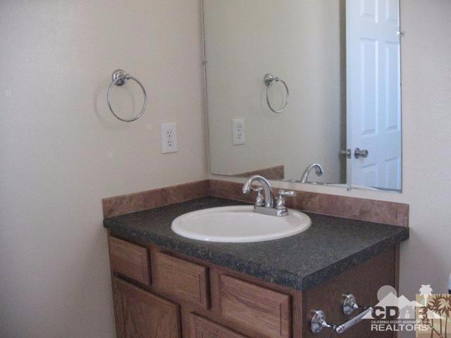 13827 Ocotillo Road Desert Hot Springs, CA 92240 - Photo 8 of 15 a bathroom with a sink and a mirror