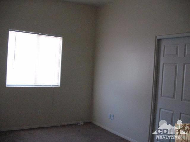 13827 Ocotillo Road Desert Hot Springs, CA 92240 - Photo 9 of 15 a room with a window