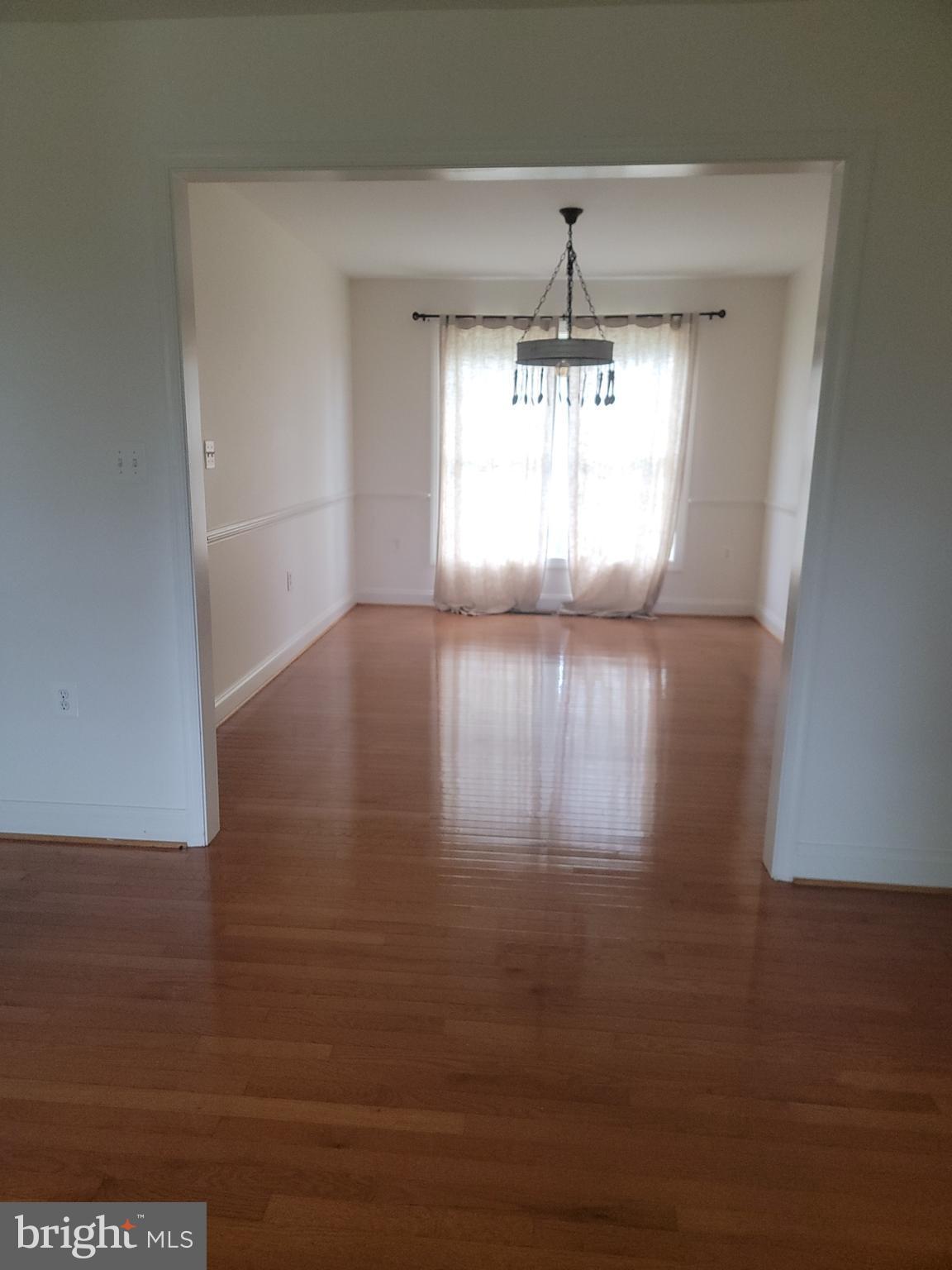 915 Virginia Avenue Culpeper, VA 22701 - Photo 6 of 24 a view of wooden floor and windows in a room