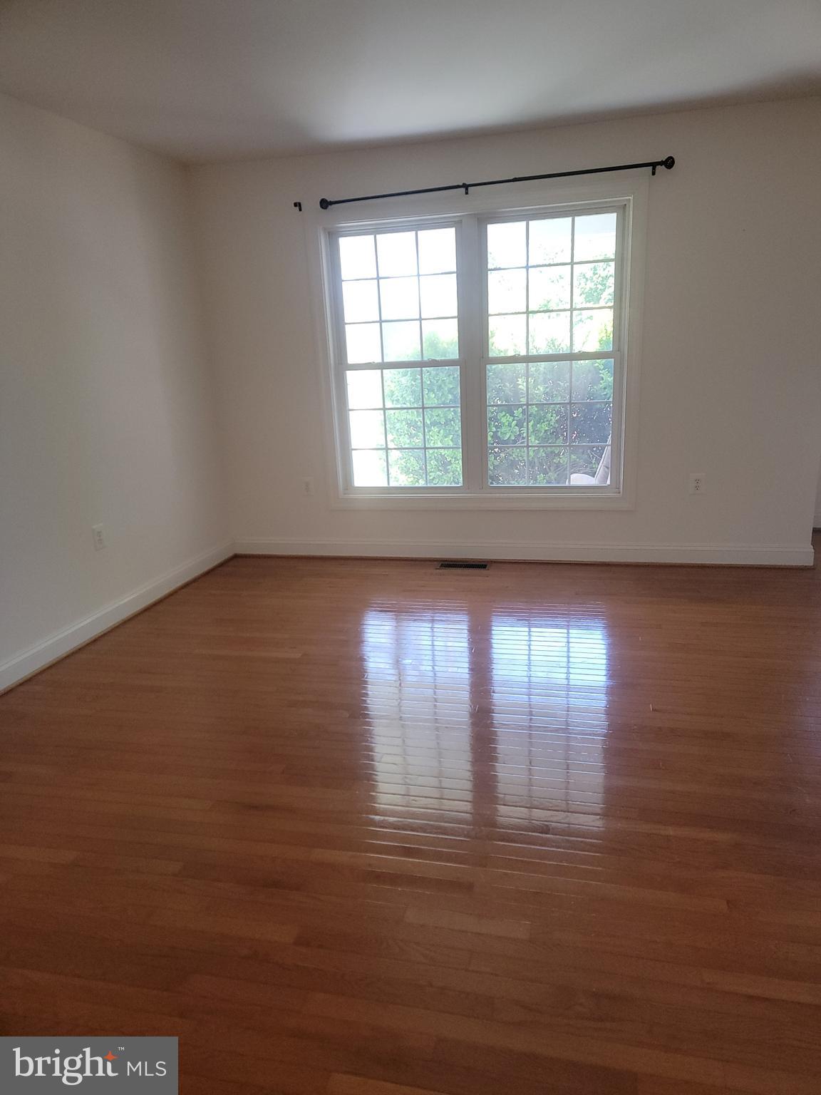 915 Virginia Avenue Culpeper, VA 22701 - Photo 10 of 24 wooden floor in an empty room with a window