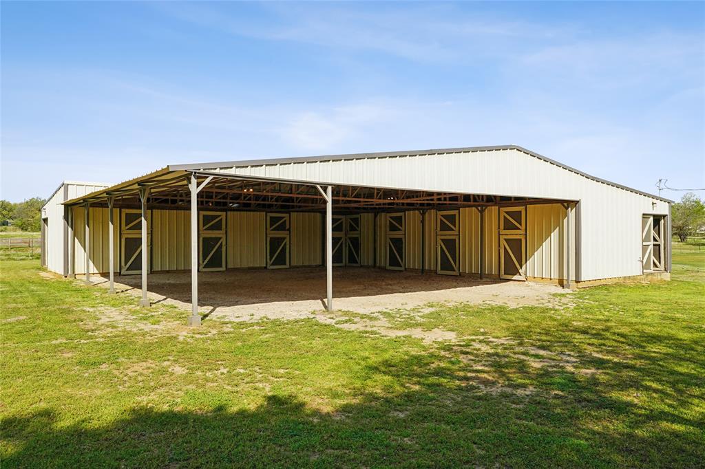 1006 Cochran Road Argyle, TX 76226 - Photo 28 of 40 8 stall barn view with 2 hallways and 1,600 sqft covered area