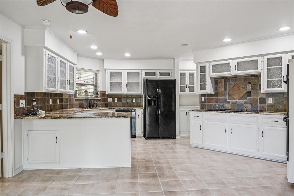 1006 Cochran Road Argyle, TX 76226 - Photo 3 of 40 Large open kitchen with granite countertops and chiseled glass cabinets