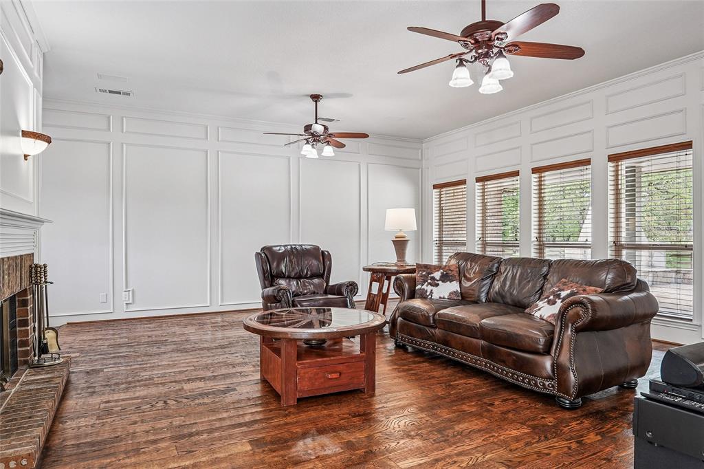 1006 Cochran Road Argyle, TX 76226 - Photo 4 of 40 Living room with solid OAK plank floors, fireplace open to kitchen and view of property from wall of windows