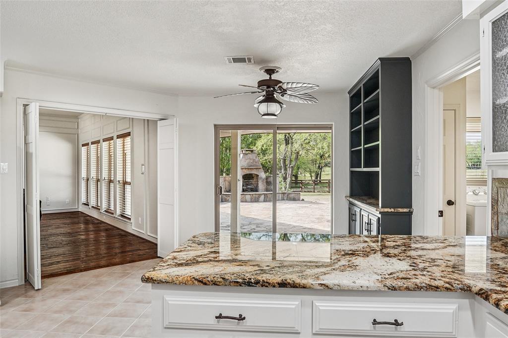 1006 Cochran Road Argyle, TX 76226 - Photo 7 of 40 Gorgeous granite countertops with view of large stone patio