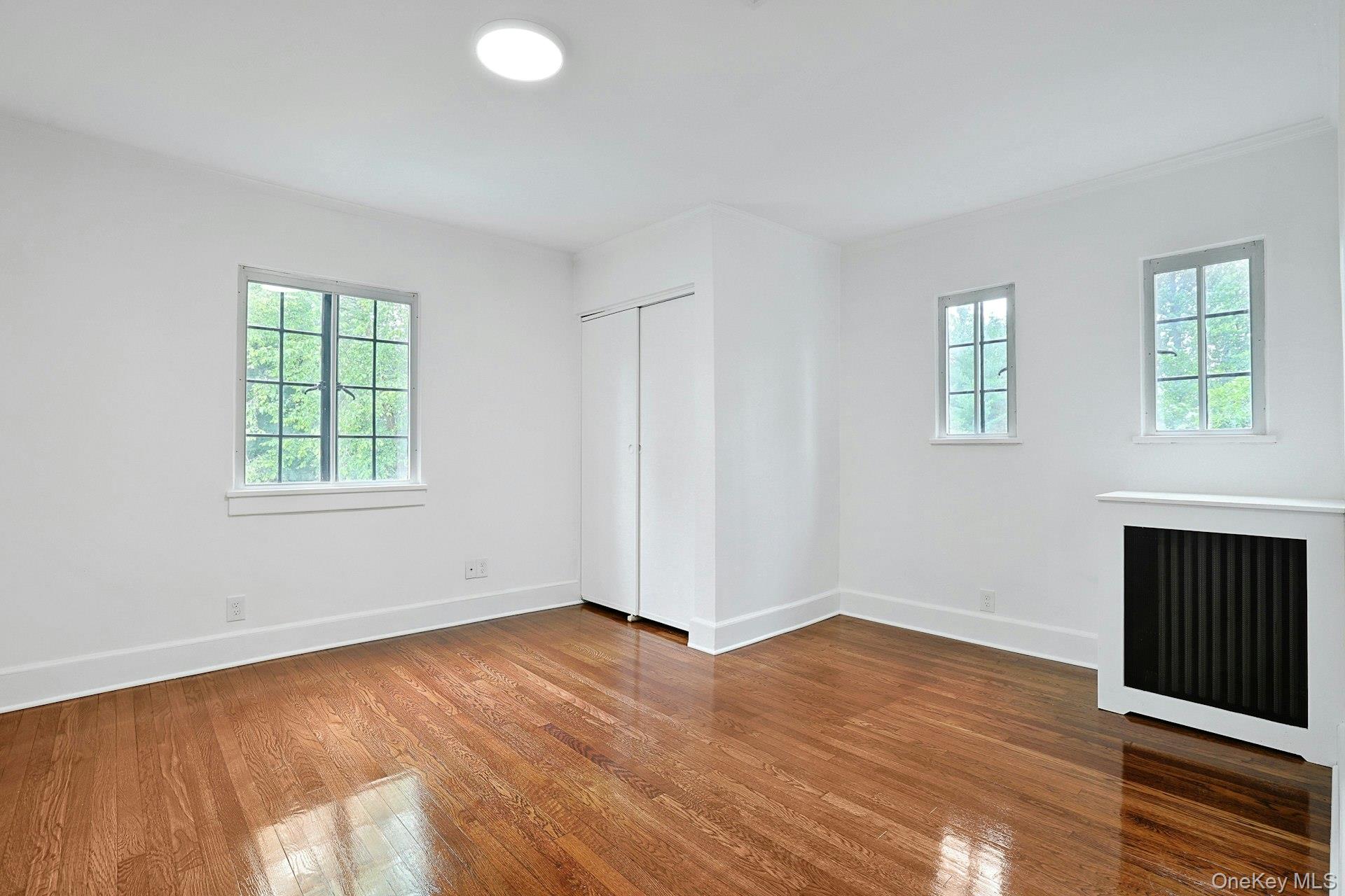 14 Withington Road Scarsdale, NY 10583 - Photo 24 of 41 an empty room with wooden floor and windows