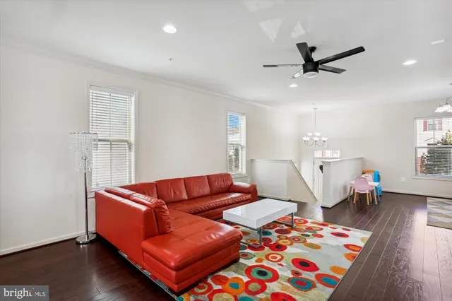 a kitchen with stainless steel appliances a dining table chairs stove and refrigerator