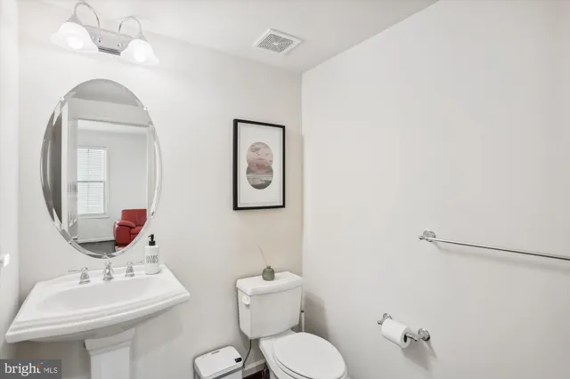 a living room with furniture gym equipment and a ceiling fan