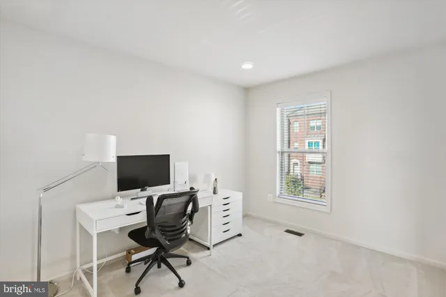 a bedroom with a bed dresser and a couch