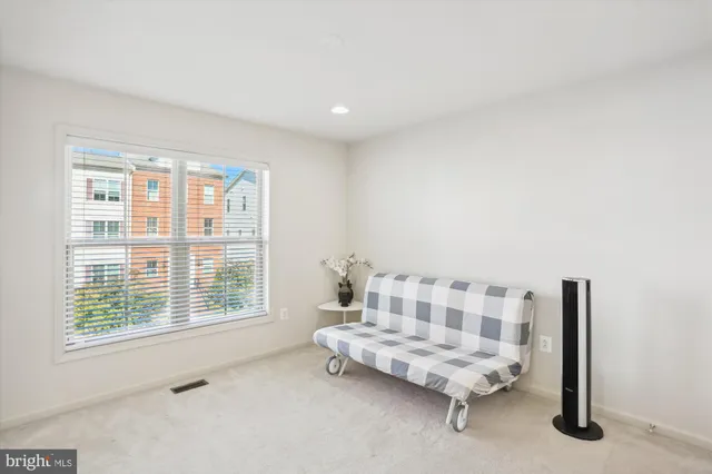 a front view of house with a garden and trees