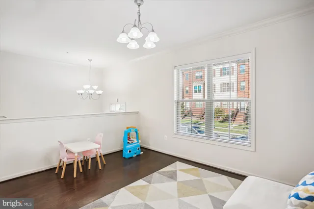 a living room with furniture kitchen view and a window