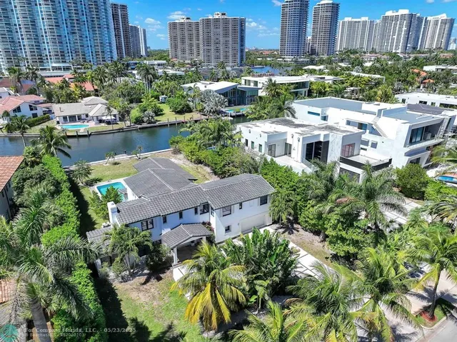 a kitchen with kitchen island stainless steel appliances a sink stove and refrigerator