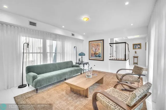 a bathroom with a granite countertop sink a toilet a mirror and shower