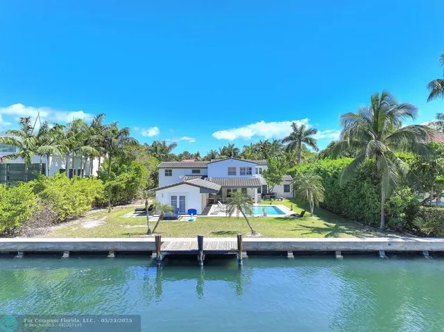 a bathroom with a double vanity sink mirror and toilet